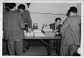 AH-03 Sweet Shop 1953/54 Lee I - customer, Alwyn Hawkes - in charge, Carl Simpson - Cashier, Fateh - contemplating purchase.